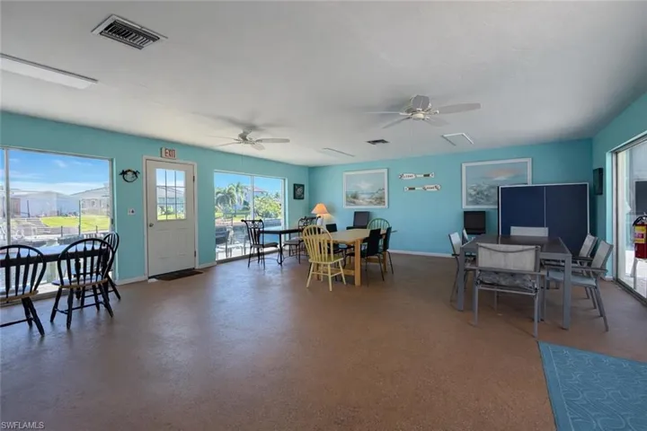 Dining area with ceiling fan, healthy amount of natural light, and concrete floors
