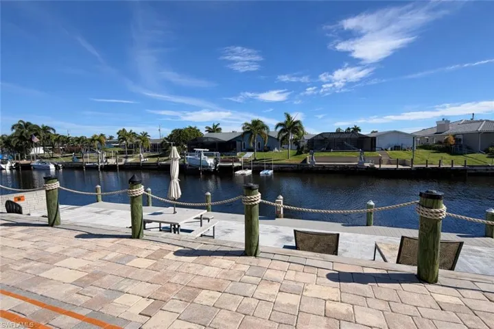 Dock area with a residential view and a water view