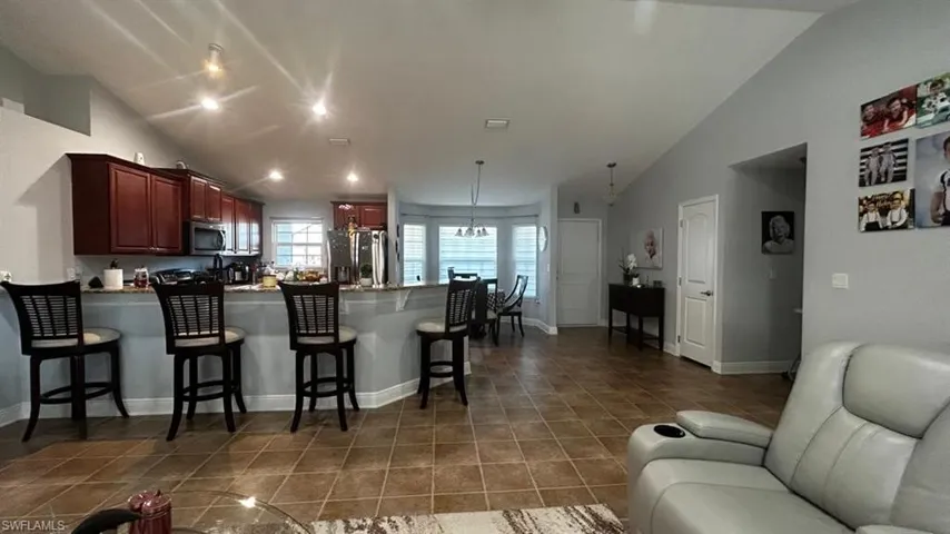 Open-concept kitchen and dining area featuring ceramic tile flooring