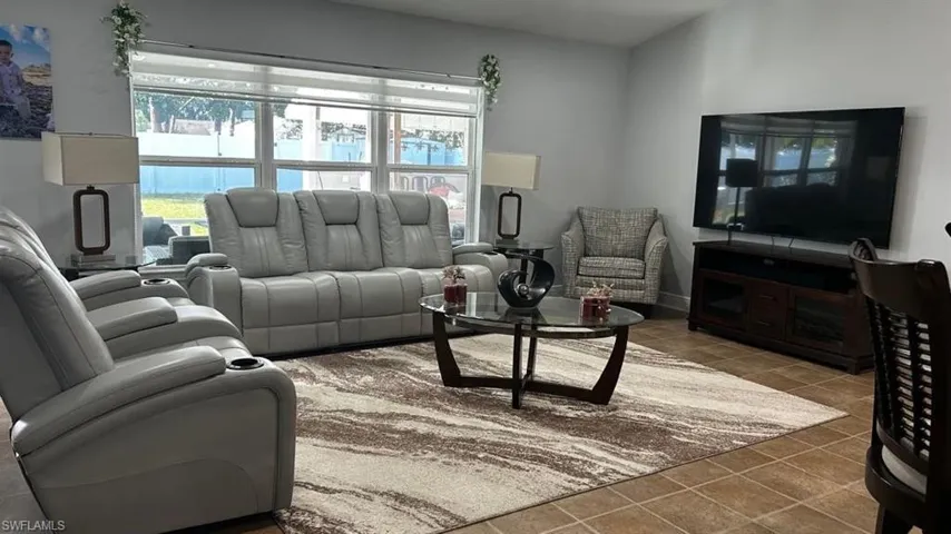 Spacious living area featuring neutral wall tones and a large window