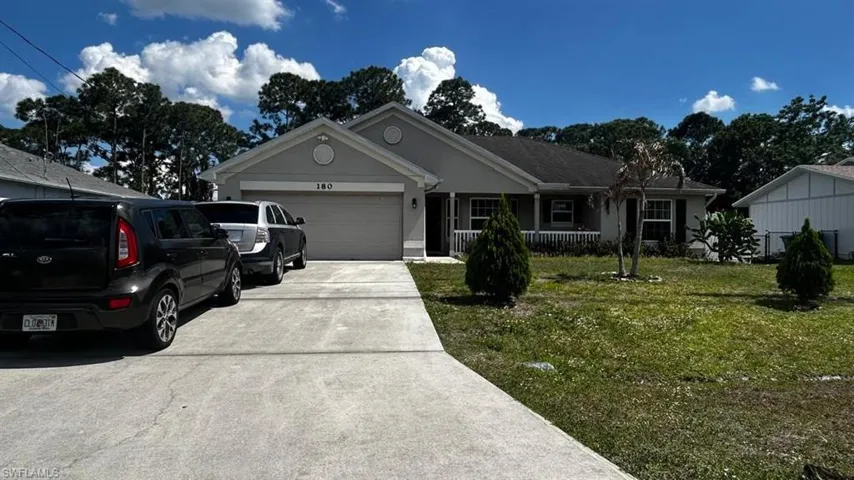 Single-story residence featuring a two-car garage and a concrete driveway