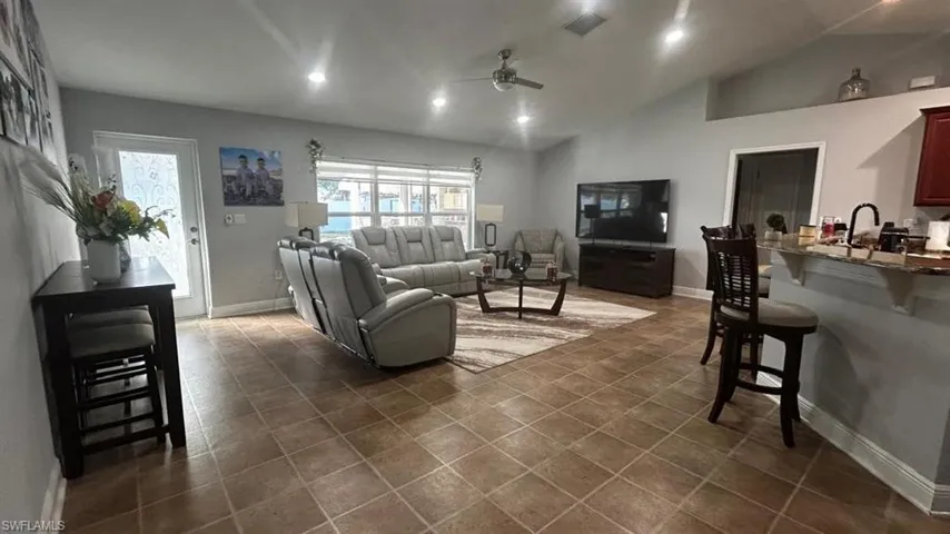 Open-concept living space featuring ceramic tile flooring and recessed lighting