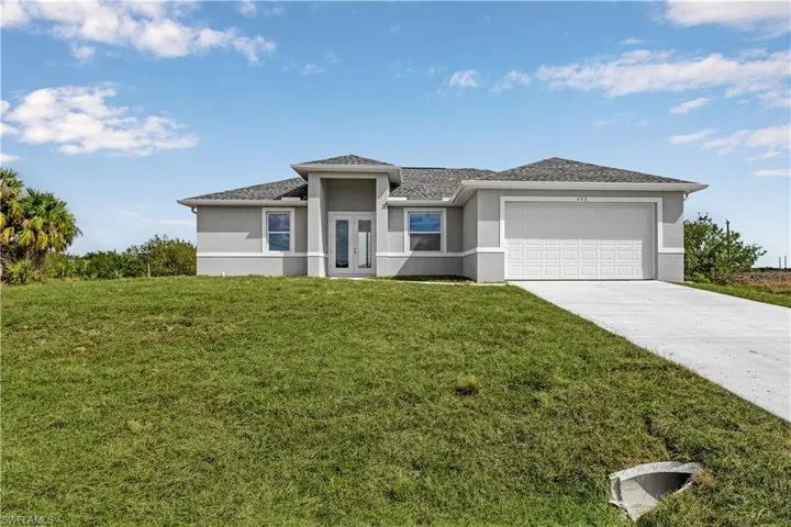 Prairie-style home with a front yard and a garage