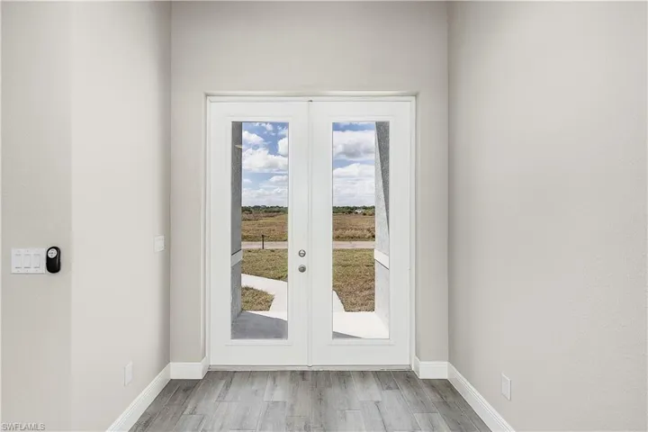 Doorway featuring french doors and light wood-type flooring