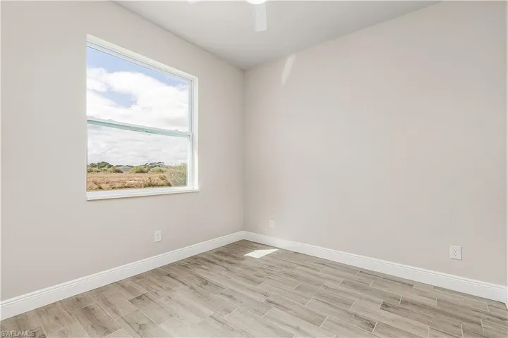Unfurnished room featuring light hardwood / wood-style flooring and ceiling fan