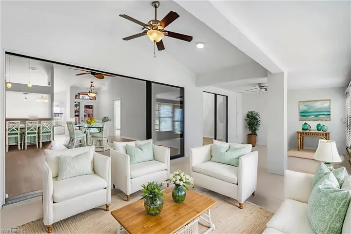 Living area featuring vaulted ceiling and a ceiling fan