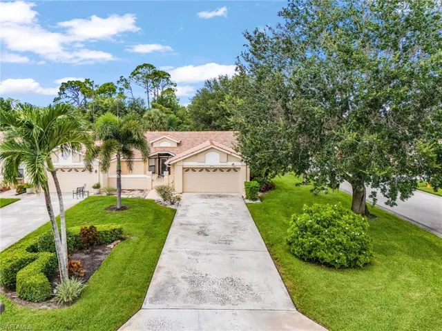 Mediterranean / spanish house featuring concrete driveway, a front lawn, stucco siding, and an attached garage
