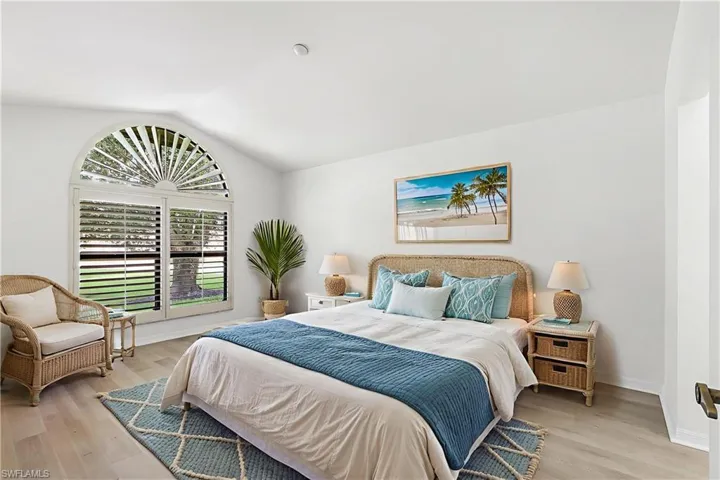 Bedroom featuring lofted ceiling and light wood-type flooring