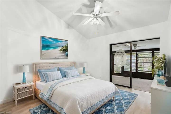 Bedroom featuring vaulted ceiling, light wood-style floors, ceiling fan, and a closet