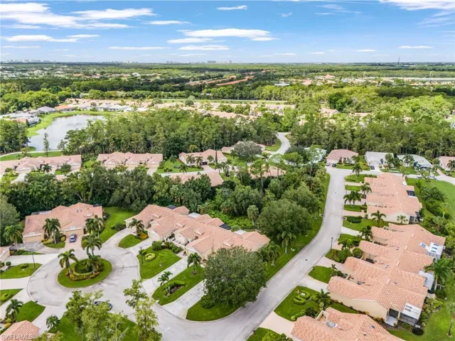 Aerial view of property and surrounding area with nearby suburban area and a large body of water