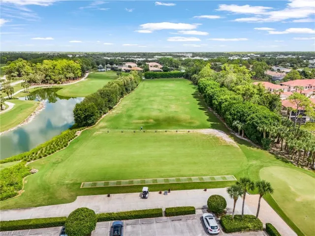 Bird's eye view of a golf course and a nearby body of water
