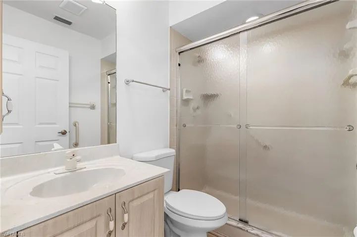Full bathroom featuring a stall shower and vanity
