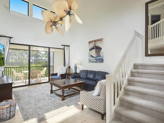 Living area with vaulted ceilings. The living room opens to a very large lanai.
