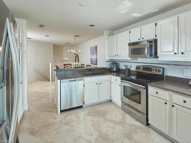 Kitchen also opens onto the enclosed lanai.