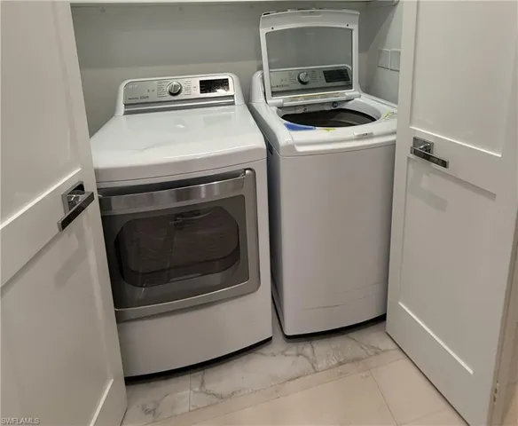 Laundry area with washer and clothes dryer