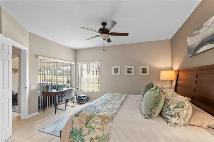 Bedroom with ceiling fan, baseboards, and wood finished floors