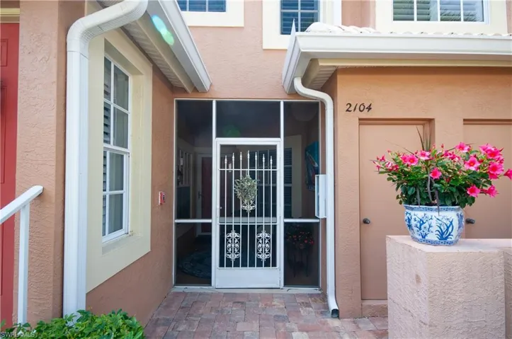 Doorway to property featuring stucco siding
