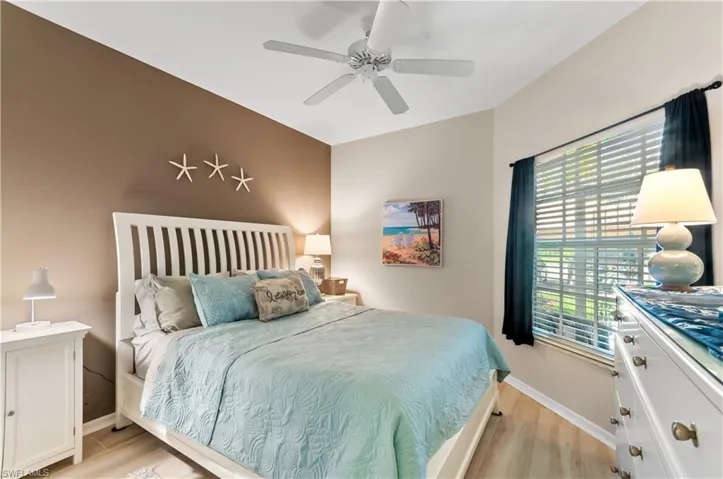 Bedroom with baseboards, ceiling fan, and light wood-style floors