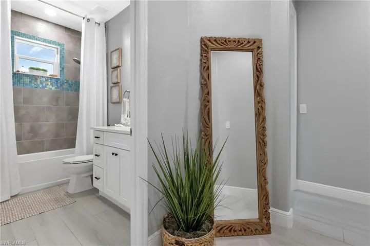 Full bathroom featuring vanity, toilet, tile patterned flooring, and shower / bath combo