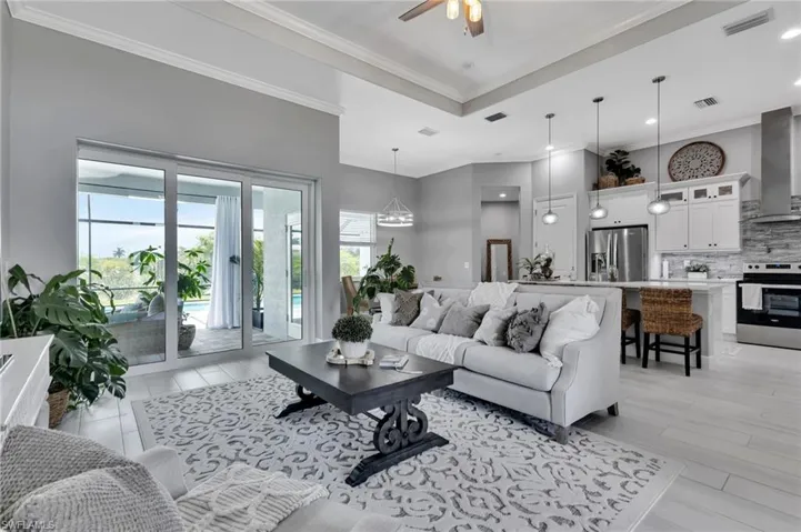 Living room featuring crown molding and ceiling fan