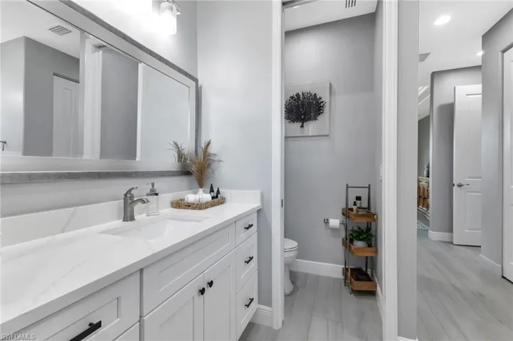Bathroom featuring vanity and toilet