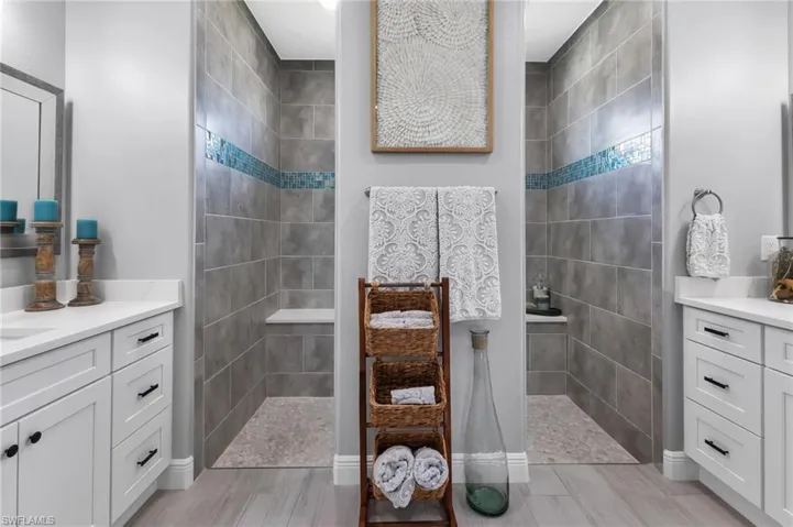 Bathroom featuring vanity and tiled shower