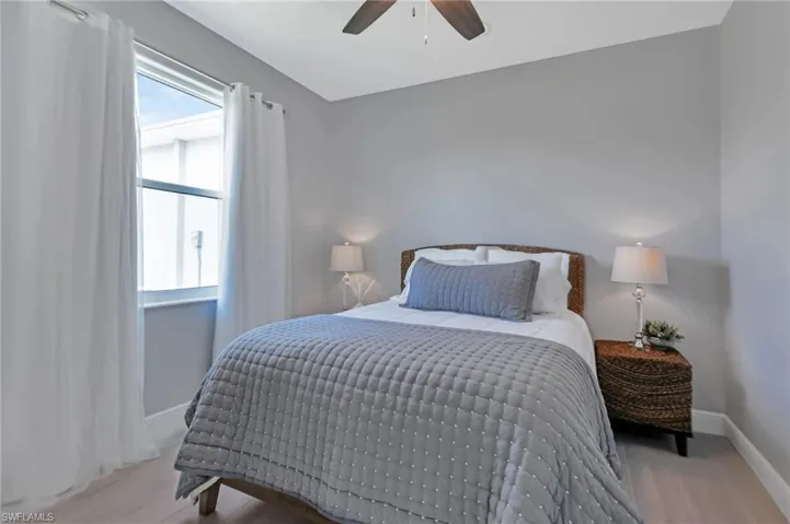Bedroom with ceiling fan and light hardwood / wood-style floors