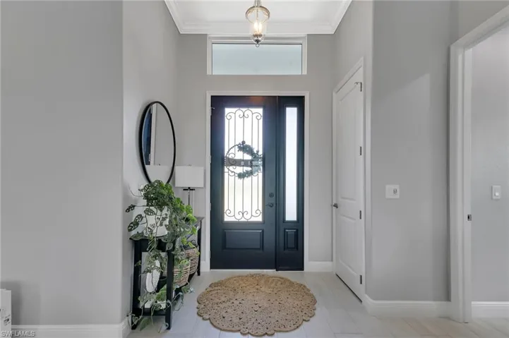Tiled foyer with ornamental molding
