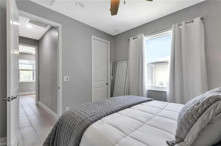 Bedroom featuring multiple windows and ceiling fan