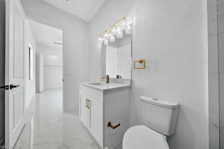 Bathroom with light marble finish floors and vanity