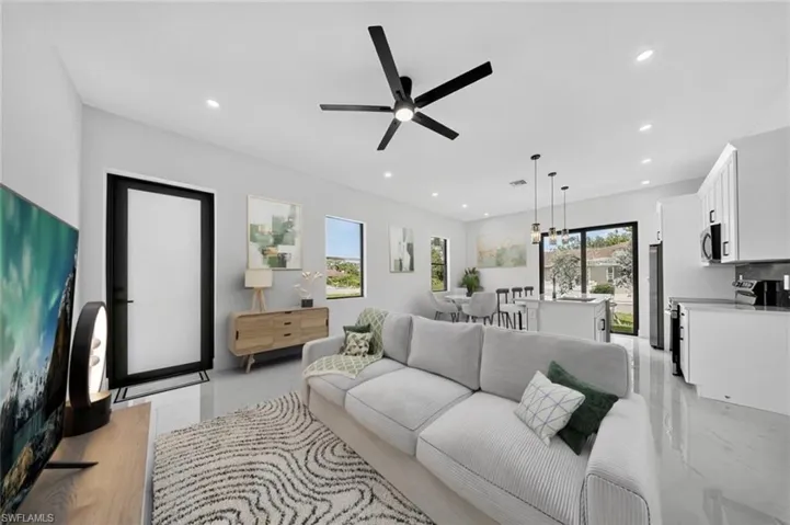 Living area featuring healthy amount of natural light, recessed lighting, and ceiling fan