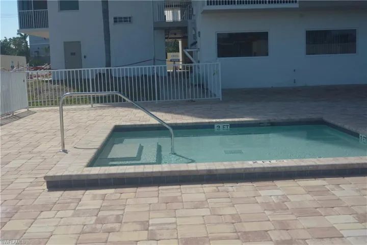 View of swimming pool featuring electric panel