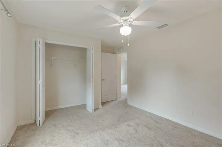 Unfurnished bedroom with carpet floors, a closet, and ceiling fan