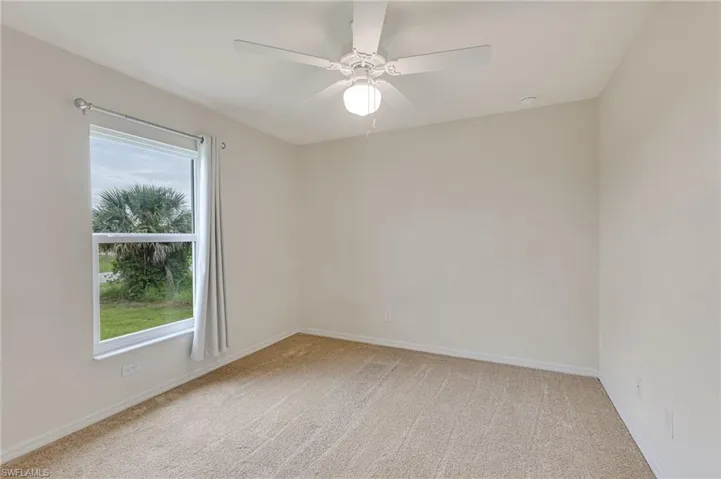 Spacious room with light carpet and abundant natural light