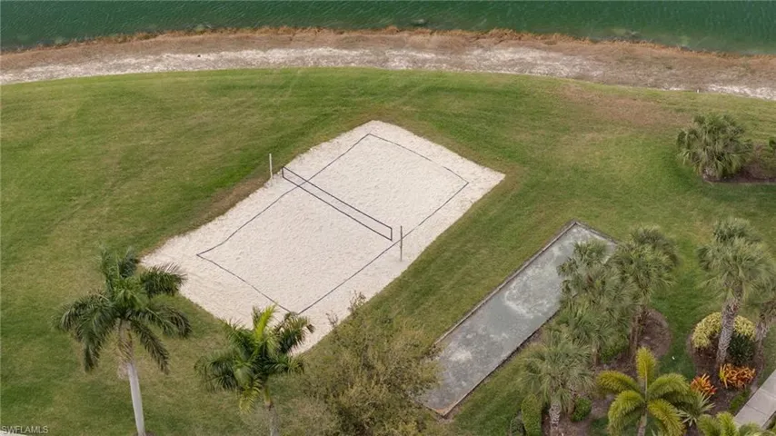 View of grassy yard with volleyball court