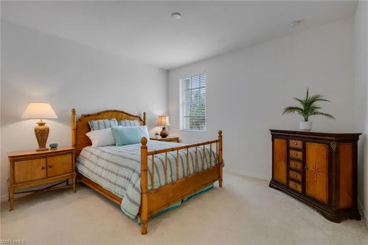 Bedroom with light carpet and baseboards