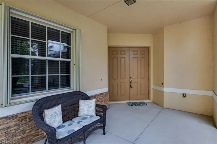 View of exterior entry with stucco siding and stone siding