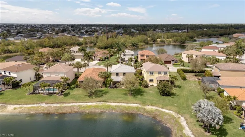Aerial view of residential area featuring a large body of water