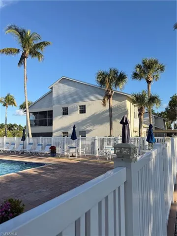 Back of property with a community pool