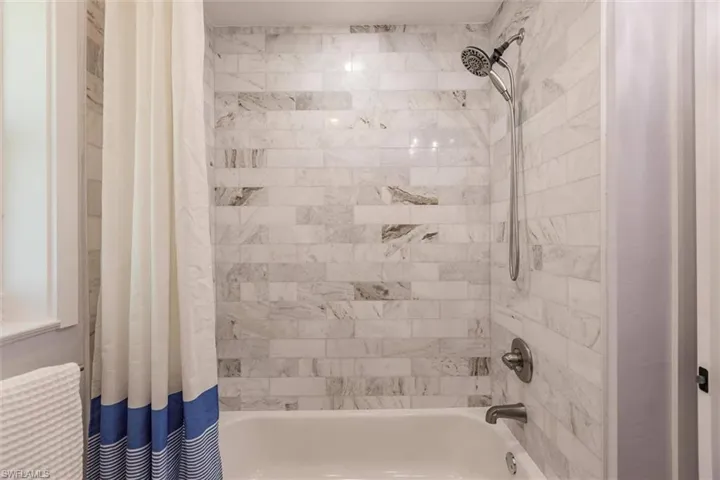 Bathroom featuring shower / bath combination with curtain