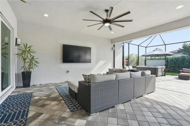 View of patio with a sunroom, outdoor lounge area, ceiling fan, and a lanai