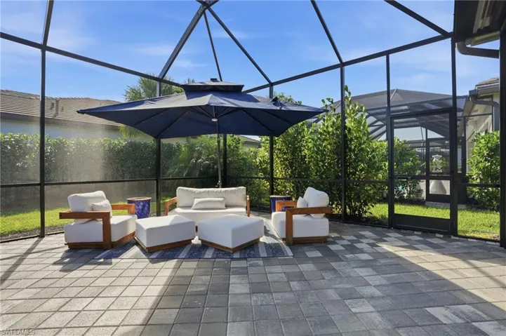 View of patio with a lanai, a sunroom, and an outdoor hangout area