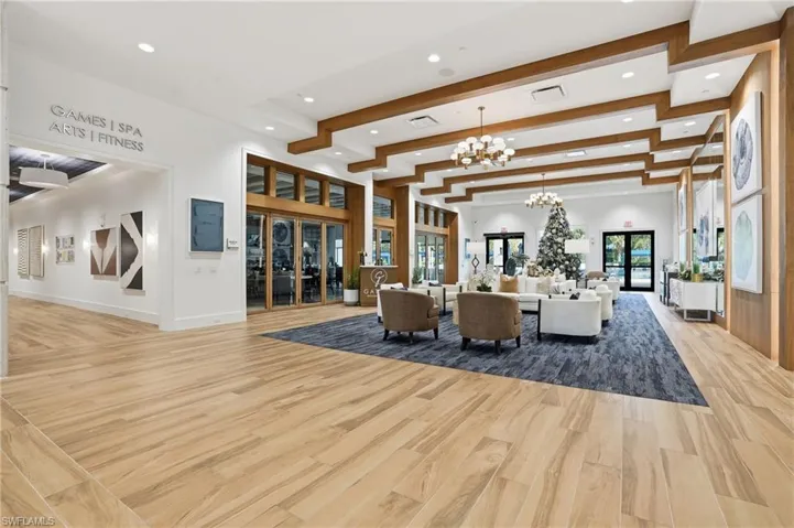 Living area with light wood finished floors, a chandelier, french doors, beamed ceiling, and recessed lighting