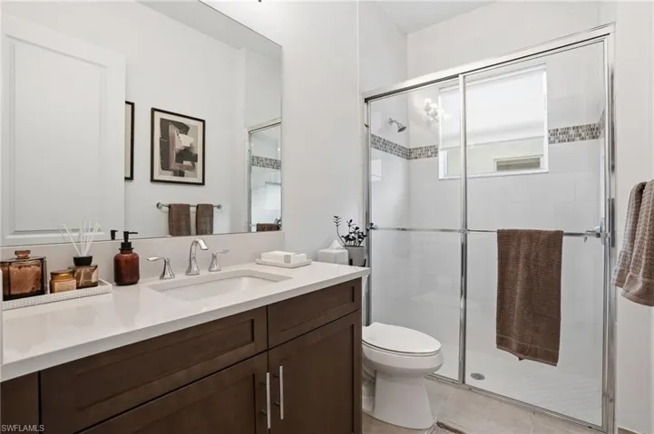 Full bathroom featuring a shower stall and vanity