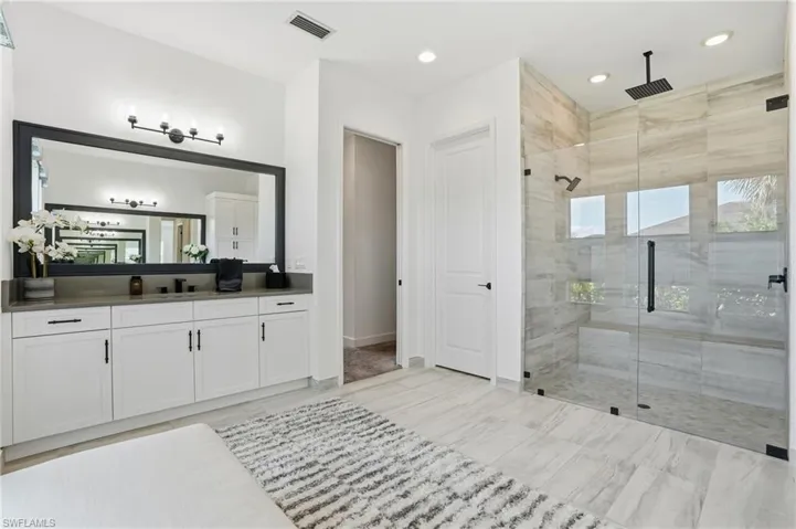 Full bath with vanity and a shower stall