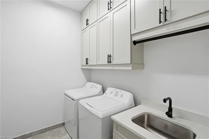 Washroom with washer and dryer and cabinet space