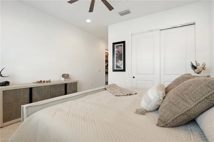 Bedroom with a closet, carpet floors, a ceiling fan, and recessed lighting