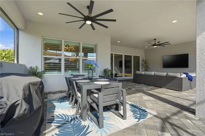 View of patio / terrace with a ceiling fan, outdoor dining space, an outdoor living space, and grilling area