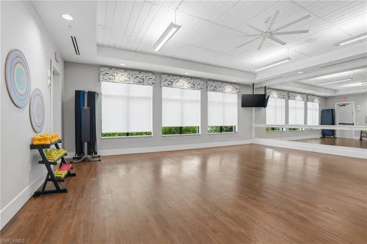 Workout area with a ceiling fan and recessed lighting