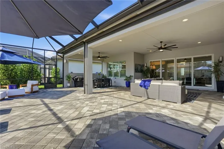 View of patio / terrace featuring an outdoor living space, ceiling fan, a sunroom, and outdoor dining area